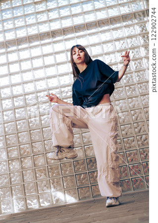 Dynamic dance performance indoors showcasing contemporary street style and urban fashion Dynamic dance performance indoors showcasing contemporary street style and urban fashion 122902744