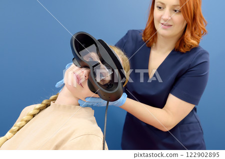 Neurologist performing positional testing of patient using videonystagmography . VNG testing uses goggles with infrared cameras to track eye movements, and can help to determine if the patient is 122902895