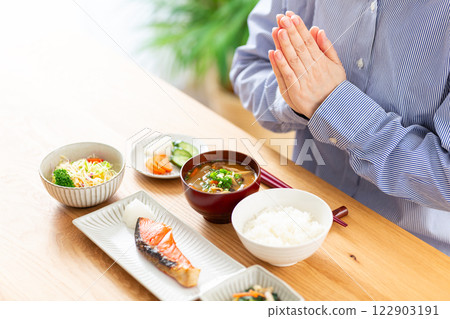Hands of a middle-aged woman eating a Japanese breakfast Hands of a middle-aged woman eating a Japanese breakfast 122903191