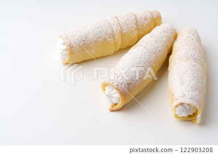 Delicious cream-filled pastries on a light background showcasing culinary artistry and dessert indulgence 122903208