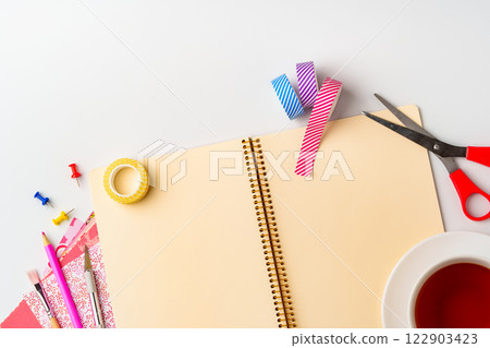 Creative workspace setup features colorful supplies and notebook for DIY projects in a bright, organized environment Creative workspace setup features colorful supplies and notebook for DIY projects in a bright, organized environment 122903423