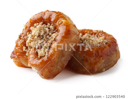 Delightful sweet pastries coated in syrup served on a white background Delightful sweet pastries coated in syrup served on a white background 122903540