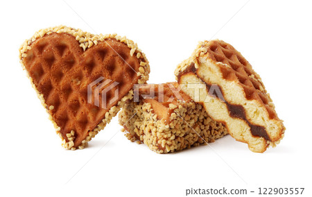 Heart-shaped and rectangular waffle snacks with nutty coating and caramel filling in a bright setting Heart-shaped and rectangular waffle snacks with nutty coating and caramel filling in a bright setting 122903557