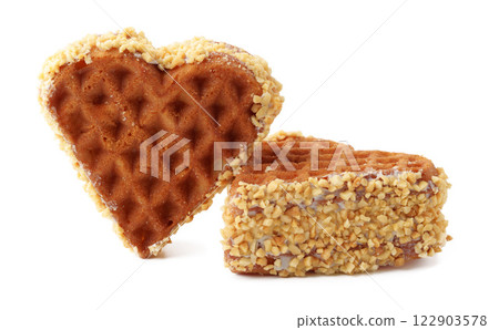 Heart-shaped waffle coated in crushed nuts makes a delightful treat for dessert lovers Heart-shaped waffle coated in crushed nuts makes a delightful treat for dessert lovers 122903578