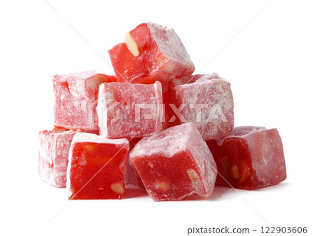 Colorful red fruit candy cubes stacked on a white background display playful sweetness and texture 122903606