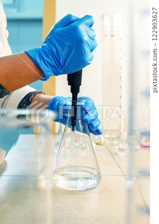 Experimenting with liquid manipulation in a laboratory setting during daylight hours 122903627