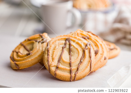 Sweet chocolate cookies on white table. 122903922