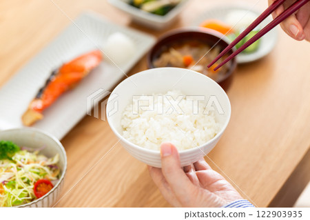 Hands of a middle-aged woman eating a Japanese breakfast Hands of a middle-aged woman eating a Japanese breakfast 122903935