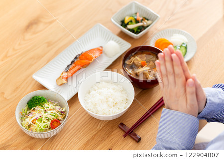 Hands of a middle-aged woman eating a Japanese breakfast Hands of a middle-aged woman eating a Japanese breakfast 122904007