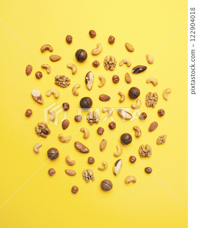 Pattern of nuts mix on yellow background Pattern of nuts mix on yellow background 122904018