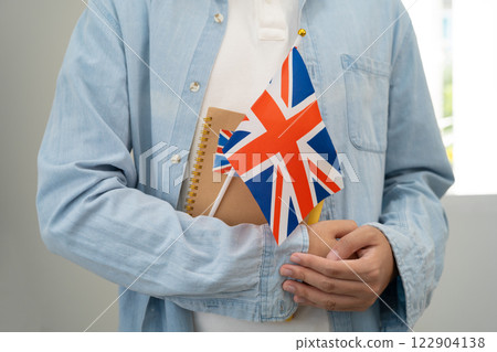 Learn English language, Asian teenage student hold book with flag in course at school. Learn English language, Asian teenage student hold book with flag in course at school. 122904138
