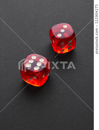 Red and white dices on a black 122904275