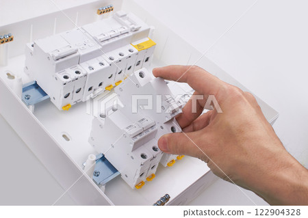 Automatic circuit breakers with hand, isolated on a white background 122904328