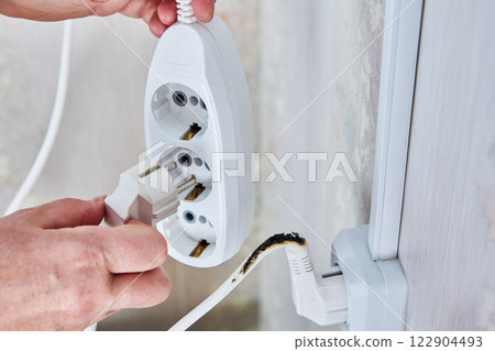 Plugging into damaged power strip with burnt cord. 122904493