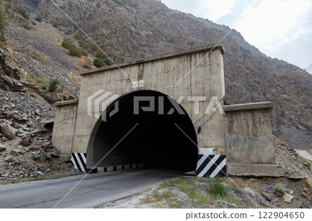 Entrance to tunnel along M34 highway in Tajikistan with rugged mountain backdrop Entrance to tunnel along M34 highway in Tajikistan with rugged mountain backdrop 122904650