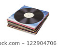 Vinyl record on a stack paper envelopes. Analog sound. Classic audio. Isolated on white 122904706