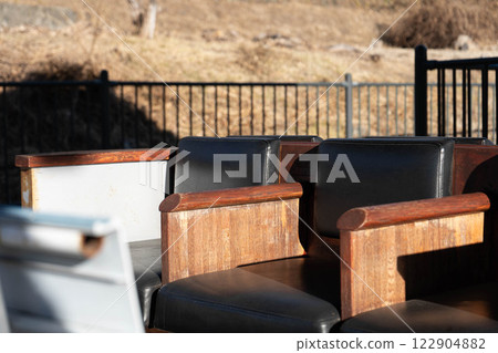 A bench bathed in winter sunlight 122904882