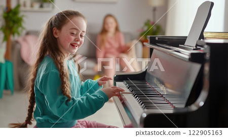 Joyful Teenage Girl with Down Syndrome Expressing Emotions while Playing Piano Artistic and Heartfelt Moment 122905163