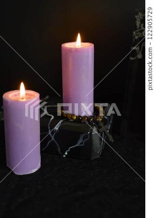 funeral, a photo frame, candles, marble urn for ashes, spiritual bracelet with black cross 122905729