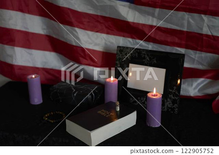 funeral an American hero, photo frame, candles, marble urn for ashes, holy bible and spiritual bracelet with black cross funeral an American hero, photo frame, candles, marble urn for ashes, holy bible and spiritual bracelet with black cross 122905752