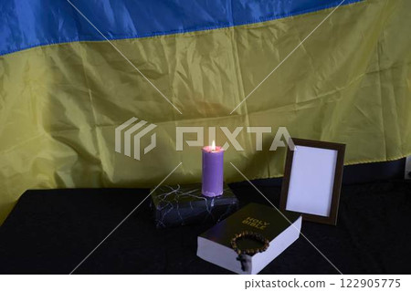 funeral of Ukrainian , photo frame, candles, marble urn for ashes, holy bible and acspiritual bracelet with black cross 122905775