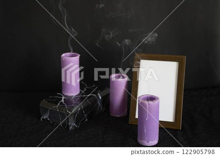 funeral, a photo frame, marble urn for ashes and smoke from extinguished candles, farewell funeral, a photo frame, marble urn for ashes and smoke from extinguished candles, farewell 122905798