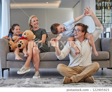 Happy family, children playing and caring mom and dad having fun while bonding, love and sitting together in the lounge at home. Man, woman and kids in house to relax, smile and enjoy time on weekend Happy family, children playing and caring mom and dad having fun while bonding, love and sitting together in the lounge at home. Man, woman and kids in house to relax, smile and enjoy time on weekend 122905925