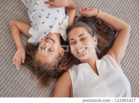 Family, children and love above a girl and mother lying on a bed in the bedroom of their home together from above. Kids, happy and smile with a woman and her cute daughter in their house to relax 122905927