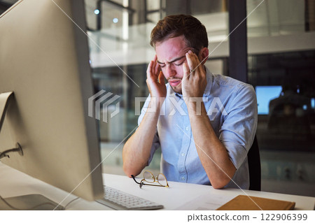 Stress, depression and mental health for night business man sitting at his computer desk with headache, anxiety and burnout from work pressure. Stressed male working late in his Australia office Stress, depression and mental health for night business man sitting at his computer desk with headache, anxiety and burnout from work pressure. Stressed male working late in his Australia office 122906399