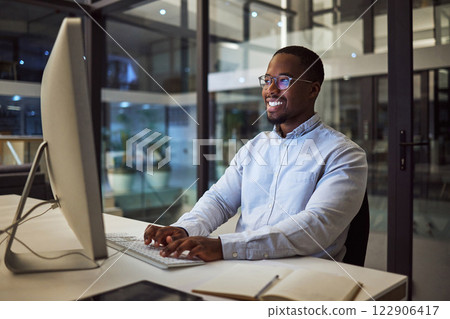 Computer, african businessman and working at night typing on keyboard for corporate research in office. Professional, happy and black man planning a management review for employee with technology 122906417
