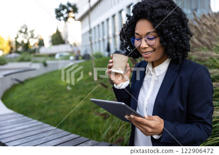 Business woman working on tablet and having morning coffee Business woman working on tablet and having morning coffee 122906472