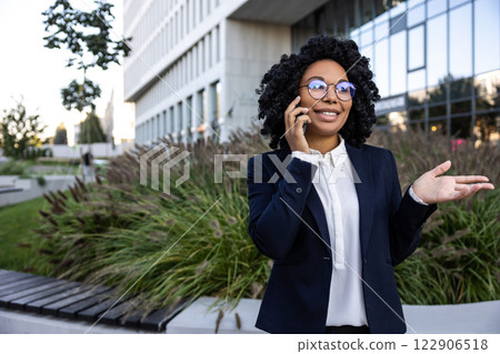Elegant good-looking business woman talking on the phone Elegant good-looking business woman talking on the phone 122906518