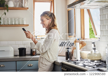 Mature woman reading phone news, social media notification and mobile apps in Australia kitchen home. Happy lady typing smartphone, online social network and 5g web technology connection in apartment 122906580