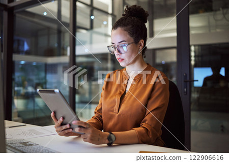 Woman working in Toronto office at night, big data analytics and reading expert research on digital tablet. Database administrator in dark, overtime work on company report and iot in tech business Woman working in Toronto office at night, big data analytics and reading expert research on digital tablet. Database administrator in dark, overtime work on company report and iot in tech business 122906616