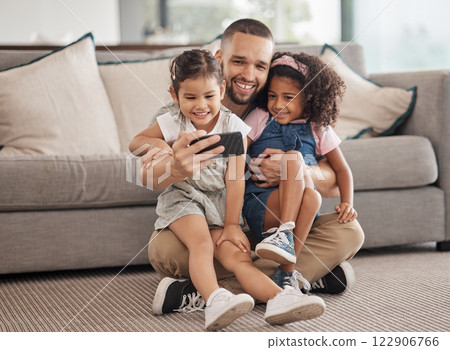 Family, selfie and happy children sitting on lounge carpet at home with phone and taking photo or doing video call together. Love, bonding and care of single parent man with girl kids in brazil house 122906766
