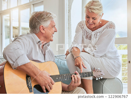 Old couple, guitar and love in home, sofa or couch playing a romantic, lovely or affection musical song for wife. Romance, retired senior man and woman play acoustic string instrument in living room. Old couple, guitar and love in home, sofa or couch playing a romantic, lovely or affection musical song for wife. Romance, retired senior man and woman play acoustic string instrument in living room. 122906767