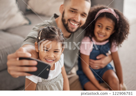 Love, father and children selfie on smartphone for cute bonding memory together in living room. Social media photograph of Mexican dad and young children relaxing in family home on weekend. 122906781