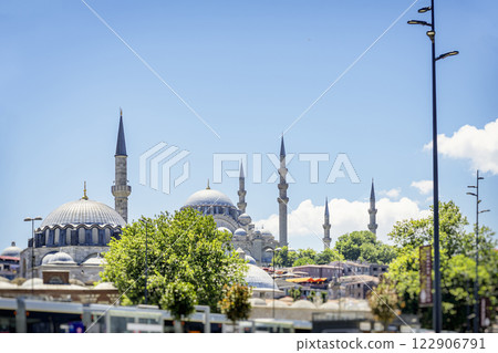 Blue Mosque. Scenic view of Istanbul's skyline with historic mosques and minarets. Greenery and modern city streets blend with Ottoman-era architecture. Vibrant urban atmosphere with cultural heritage Blue Mosque. Scenic view of Istanbul's skyline with historic mosques and minarets. Greenery and modern city streets blend with Ottoman-era architecture. Vibrant urban atmosphere with cultural heritage 122906791