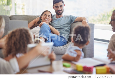 Family, children and parents love with a mother and father watching the kids while learning or playing in the living room. Happy, home and relax with a man and woman on a sofa in their home to relax 122906792