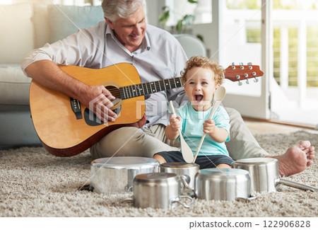 Music, pots and baby drummer with old man on living room floor with pan and wooden spoon instruments with his guitar. Memory, smile and senior grandparent enjoys time with a happy grandchild Music, pots and baby drummer with old man on living room floor with pan and wooden spoon instruments with his guitar. Memory, smile and senior grandparent enjoys time with a happy grandchild 122906828