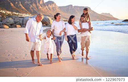 Big family, children or girls bonding on beach on summer sunset holiday, social reunion or vacation. Smile, happy and walking parents, mom and dad with relax senior grandparents and kids in Cape Town 122907073