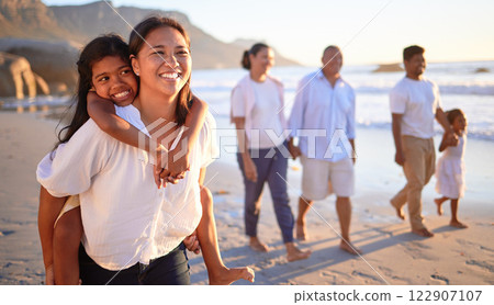 Travel, happy family and beach vacation with relax, cheerful people bonding along the sea at sunset. Love, nature and excited girl embracing her mother, enjoying freedom and fresh air with family 122907107