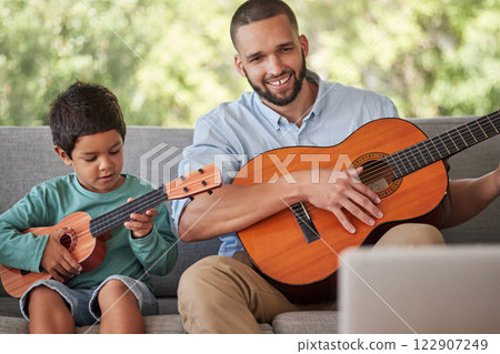 Father teaching child guitar, learning music skill in brazil home and happy singing together. Acoustic musical instrument, young guitarist plays ukulele and training with musician dad in fun family Father teaching child guitar, learning music skill in brazil home and happy singing together. Acoustic musical instrument, young guitarist plays ukulele and training with musician dad in fun family 122907249