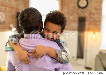 Dad and son hugging and looking happy and enjoyed 122907307