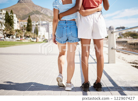 Summer, beach boardwalk and girl friends on walk in nature by the ocean during vacation. Lgbtq couple walking on a promenade along the sand and water while on tropical seaside holiday in south africa 122907427
