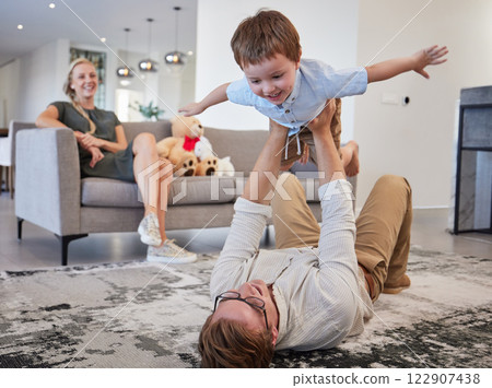 Family helicopter, child game and father with energy to relax with kid, love with care on the floor and funny in living room together in home. Happy dad and boy playing flying game in the lounge 122907438