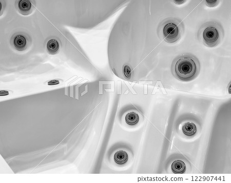 Details of a modern spa hot tub with massage jets captured in a minimalist style 122907441