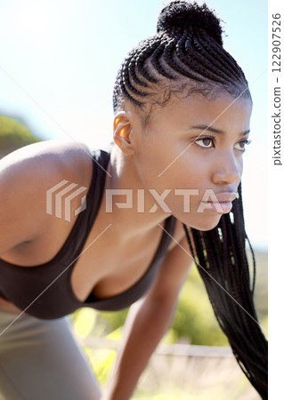 Motivation, focus and fitness black woman about to run a sport workout outdoor. Sports training, health exercise and athlete with a serious face expression about to start a strong cardio session 122907526