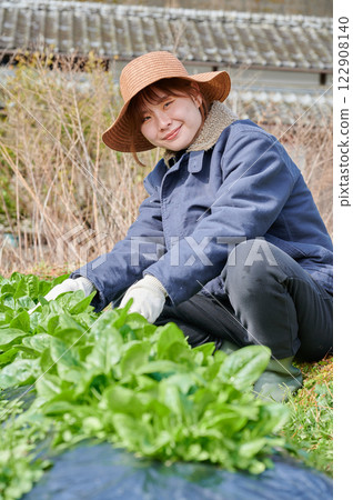 Woman working in the fields, country life, home garden 122908140