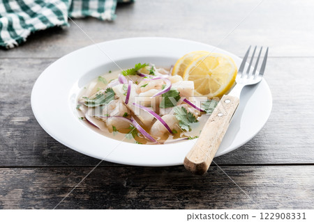Traditional Peruvian ceviche sea bass fillet on wooden table Traditional Peruvian ceviche sea bass fillet on wooden table 122908331